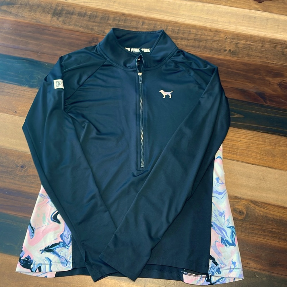 Pink pullover with thumb holes.